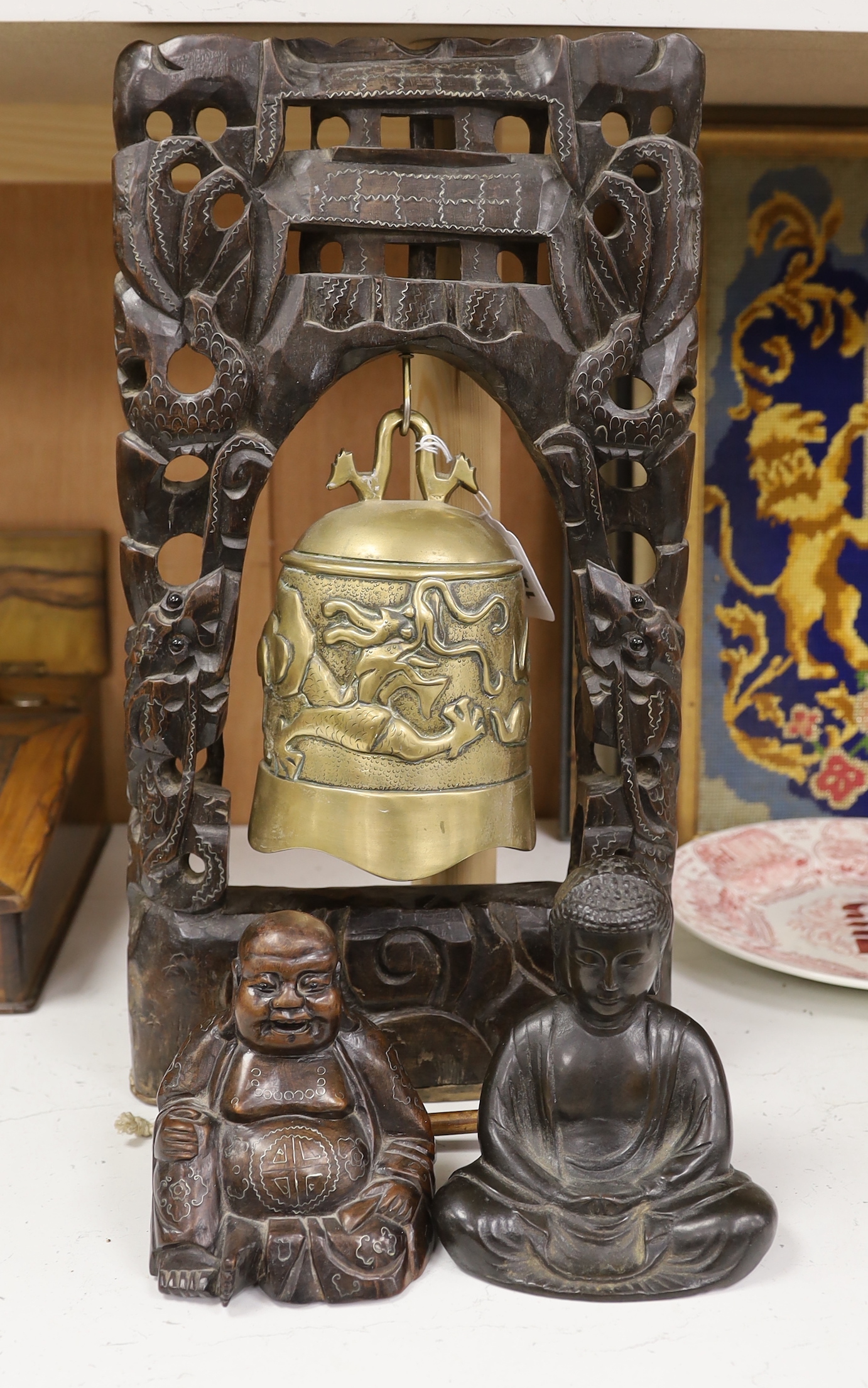 A Chinese hardwood and silver wire inlay framed bell and a similar hardwood and silver wire inlay figure of Budai, and a bronze figure of Buddha (3)